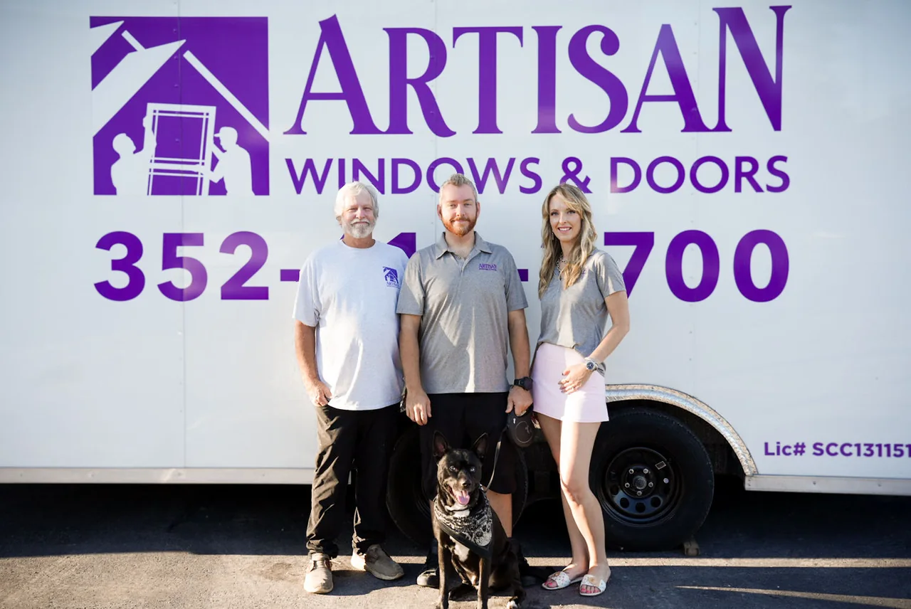 David Ware, Jeremiah Ware and Alicia Morgan with Bandit, in front of the Artisan Windows & Doors van.